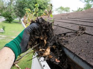 cleaning roof gutters to maintain roof condition after roof pressure washing